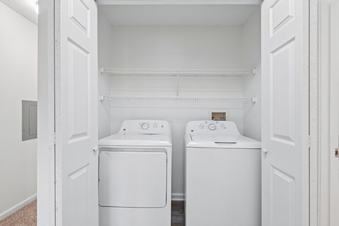 A white laundry room with a washer and dryer.
