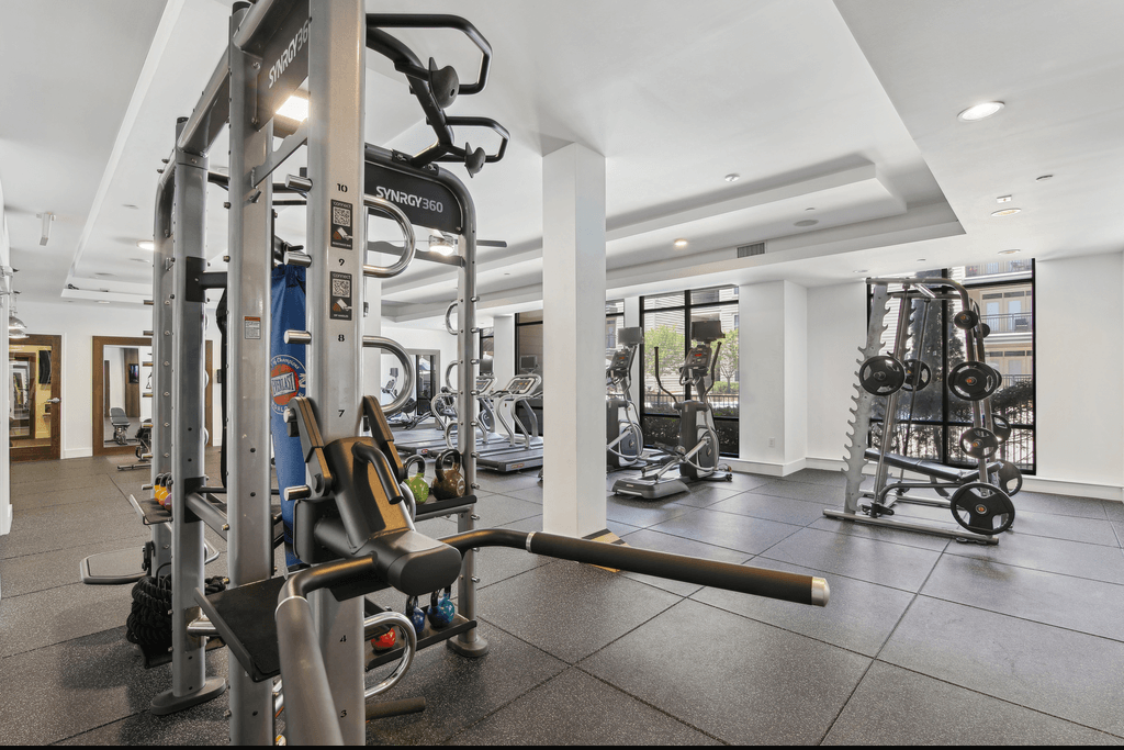 a gym with weights and other exercise equipment in a large room
