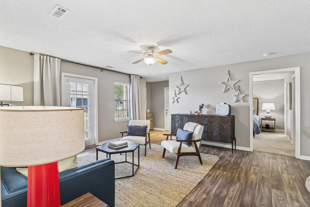 a living room with furniture and a ceiling fan