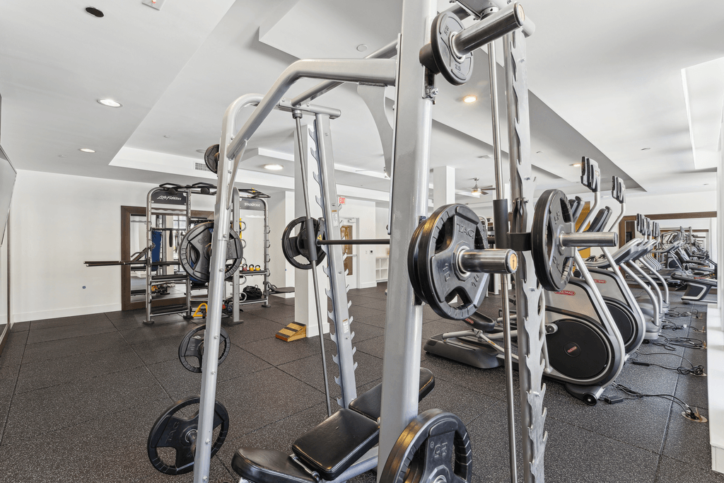 a gym with various exercise equipment and weights