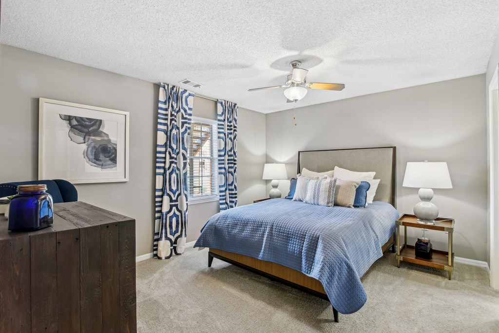 a bedroom with a bed and a ceiling fan