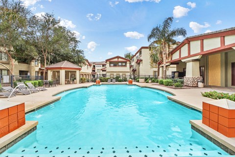 Resort style pool with covered pavilion and lounge chairs at ReNue Downtown Apartments, Phoenix, Arizona
