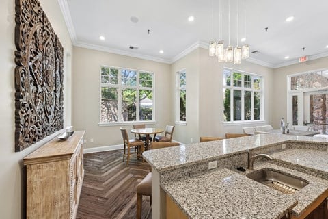 A kitchen with granite countertops and a wooden floor.