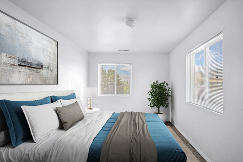 Bedroom with blue bedding and two windows at Mayflower Harbor at Pilgrims Landing Apartments, Lehi, UT 84043