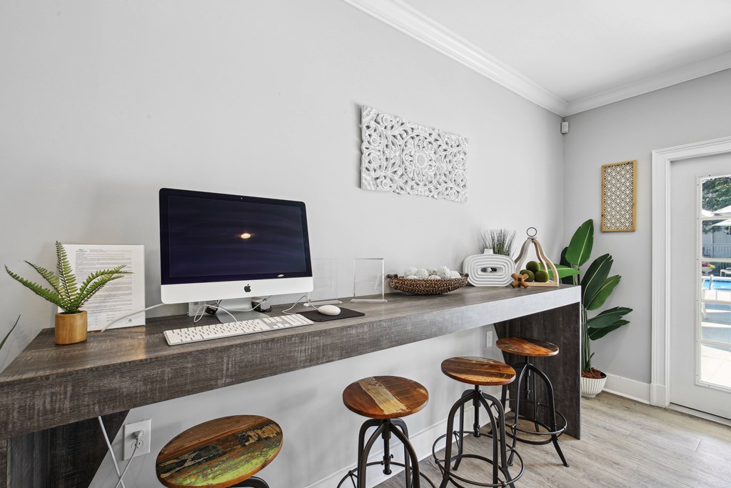 A home office with a desk, chair, and computer.