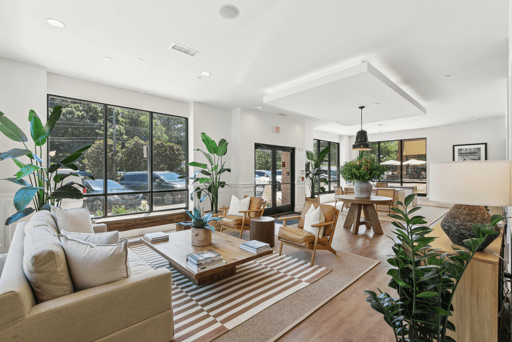 a living room with a couch and chairs and a table