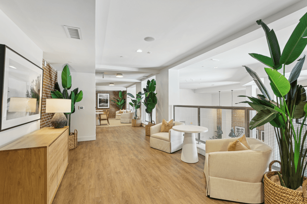 a living room with white furniture and a balcony
