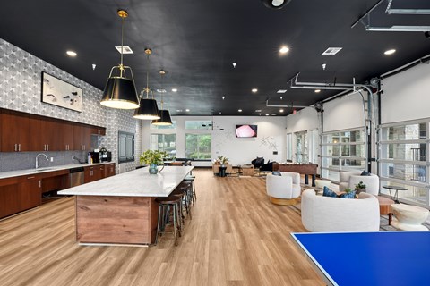 A modern kitchen with a long table and chairs.