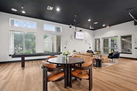 A modern dining room with a large table and chairs.