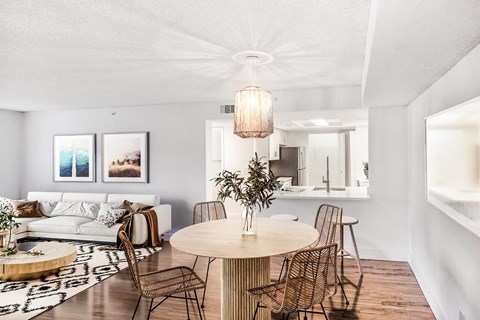 A modern dining room with a round table and chairs.