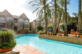 a large swimming pool with buildings in the background