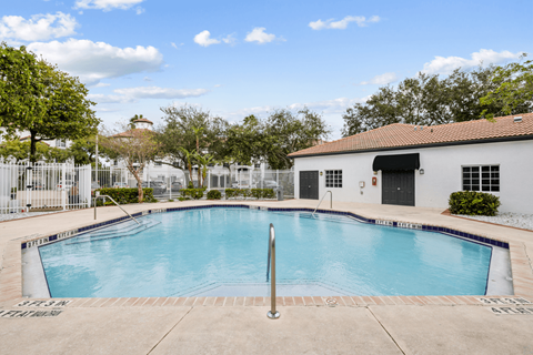 our apartments have a large swimming pool and a white building