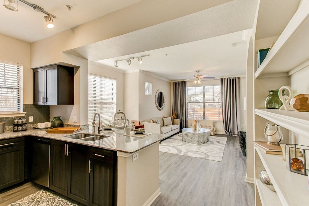 a kitchen and living room with a couch and a coffee table
