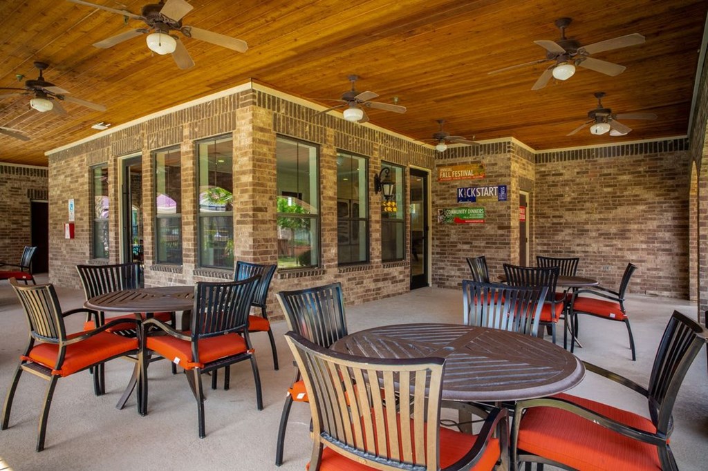 an outdoor patio with tables and chairs