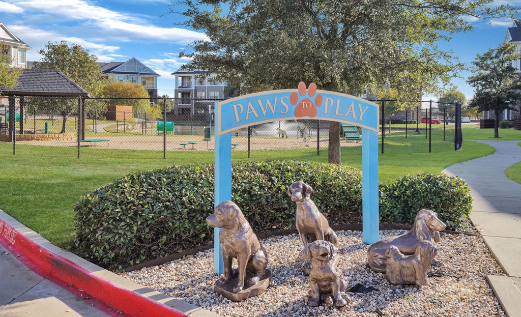 dog statues sitting outside of dog park