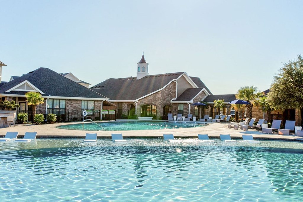 a swimming pool with lounge chairs
