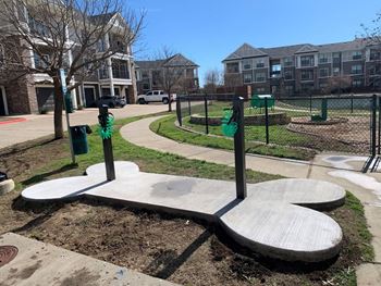 dog park with apartment building in background