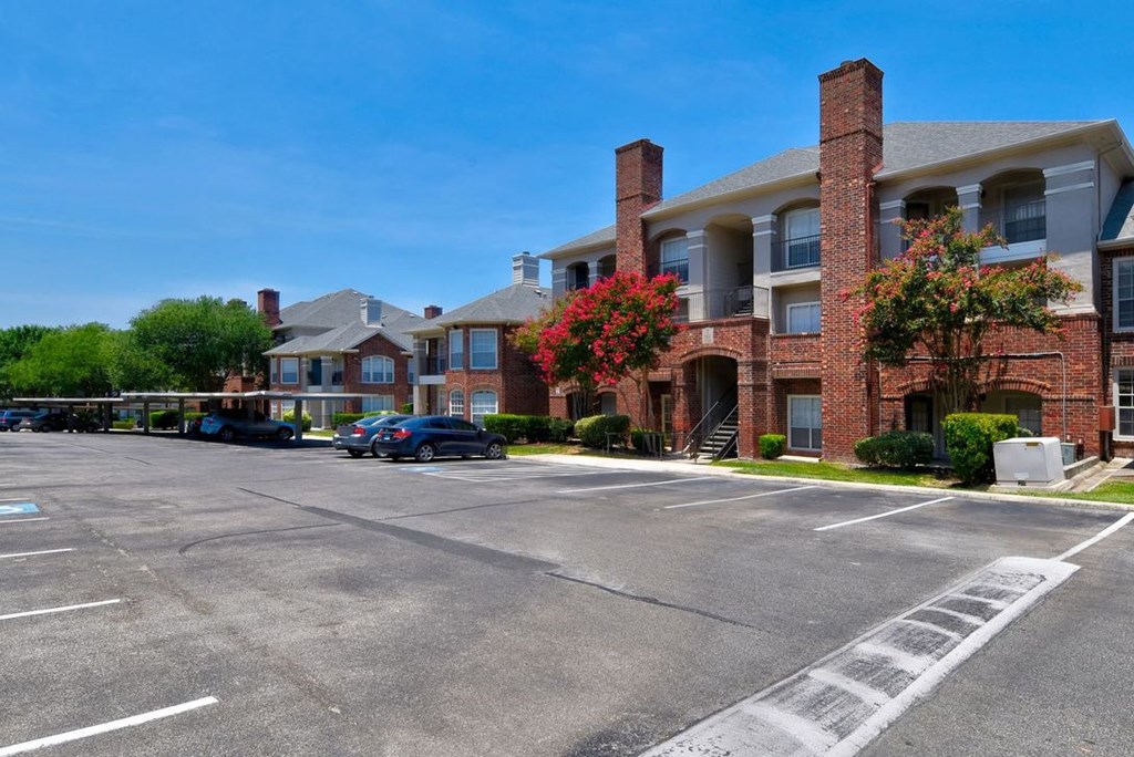 a parking lot in front of an apartment complex