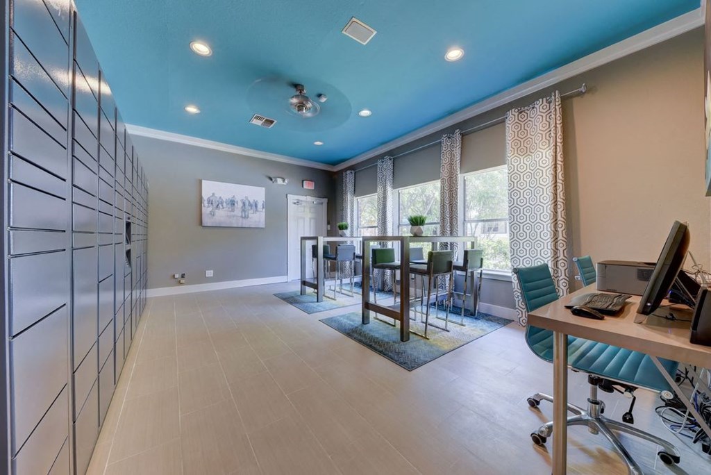 package room with a desk and chairs and a large window