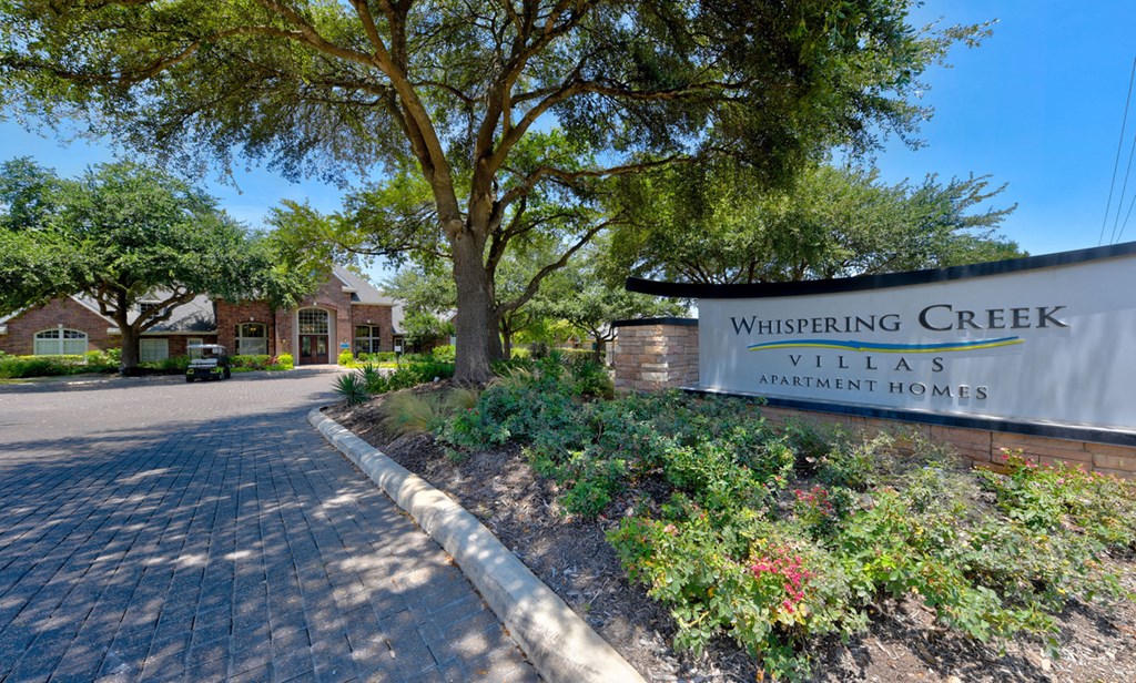 whispering creek villas apartment sign