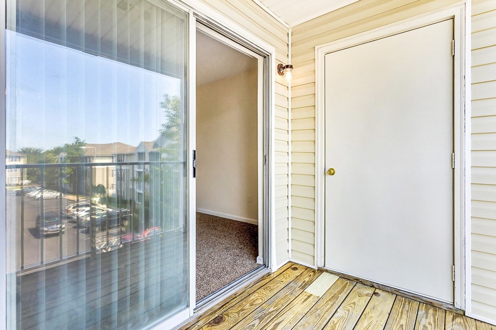 View of private patio with glass sliding door