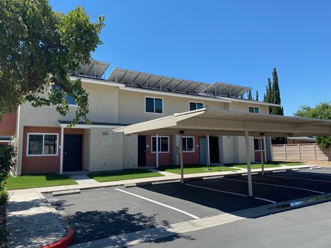 A building with a parking lot in front of it.