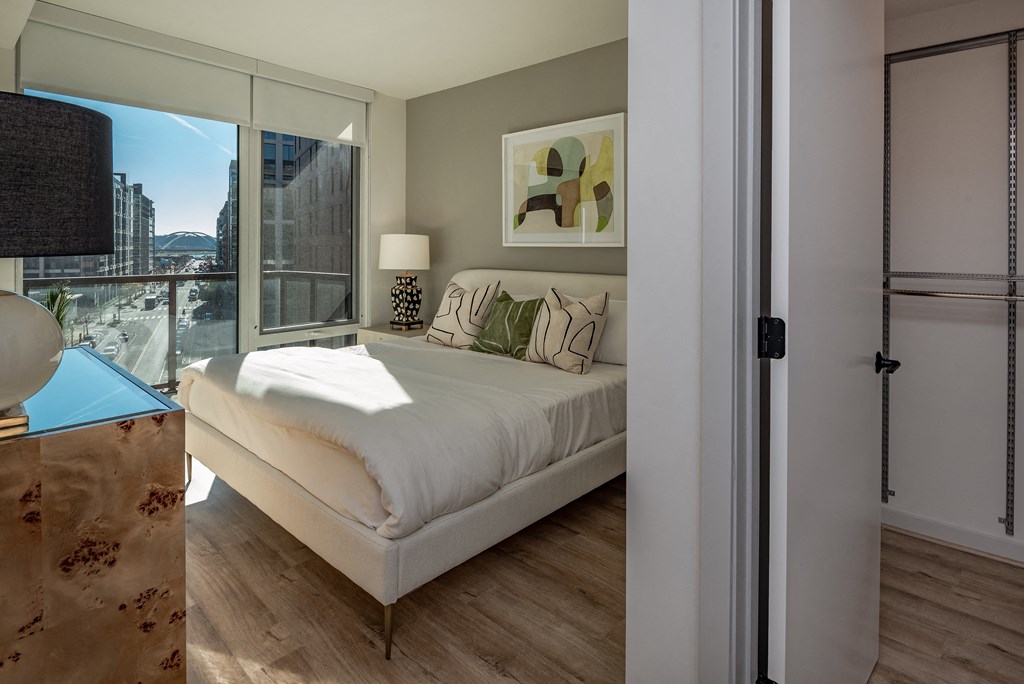 a bedroom with a bed and a large window