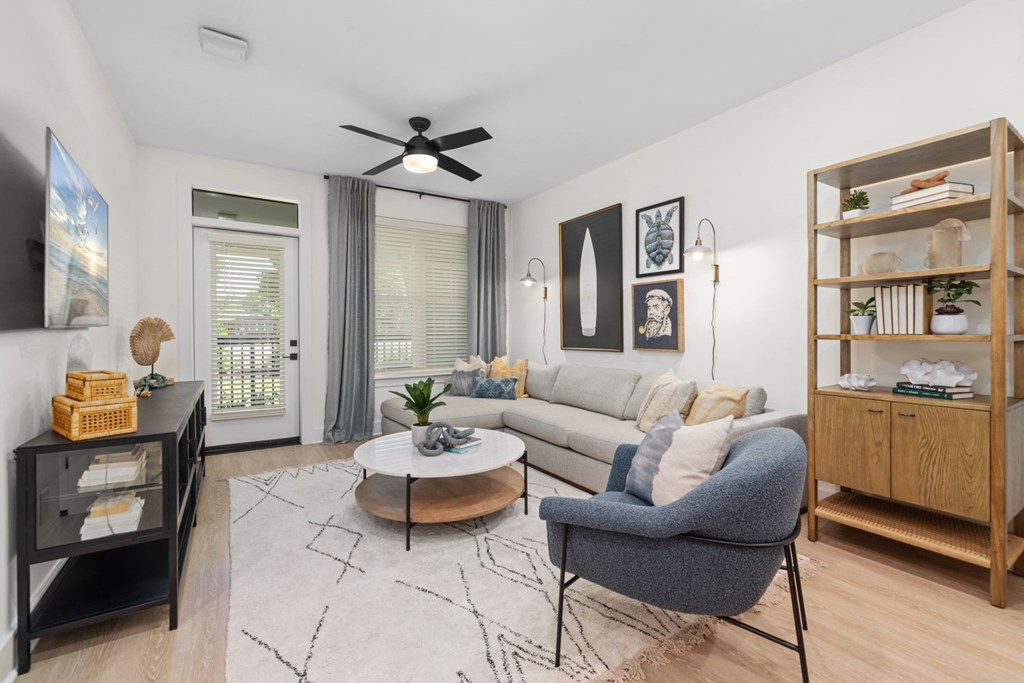 a living room with a couch and a ceiling fan