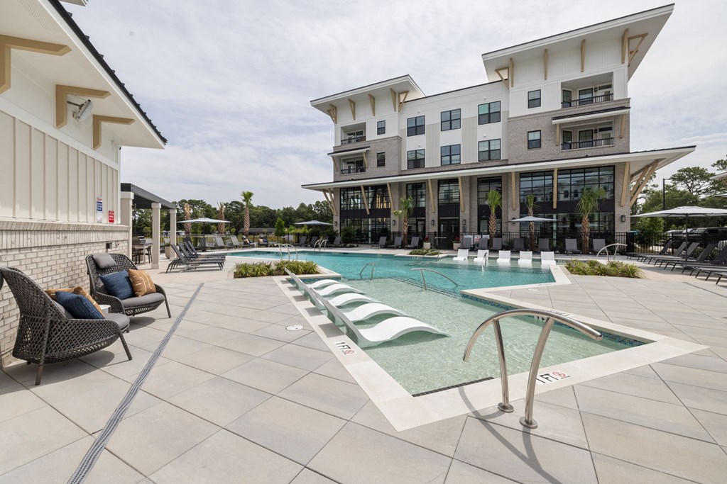 A modern building with a pool in front.