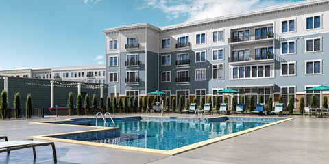 a swimming pool in front of an apartment building