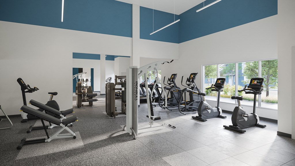 a gym with cardio machines and other exercise equipment in a building