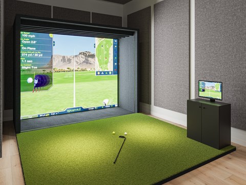a room with a golf simulator and a video screen