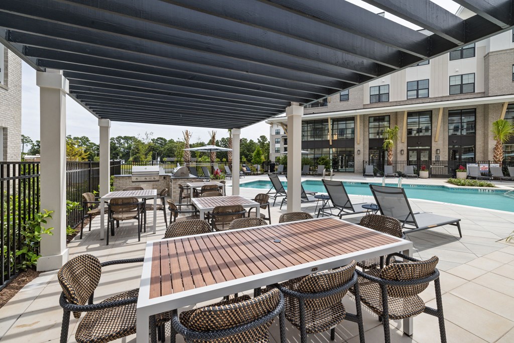 our apartments have a pool and a patio with tables and chairs