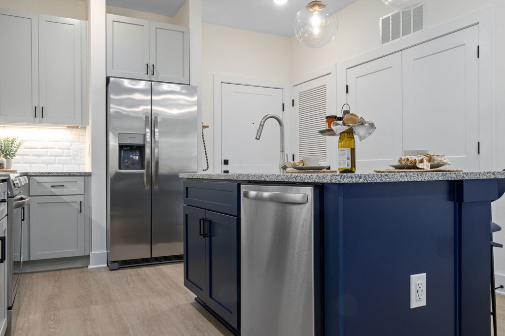 a kitchen with stainless steel appliances and blue cabinets