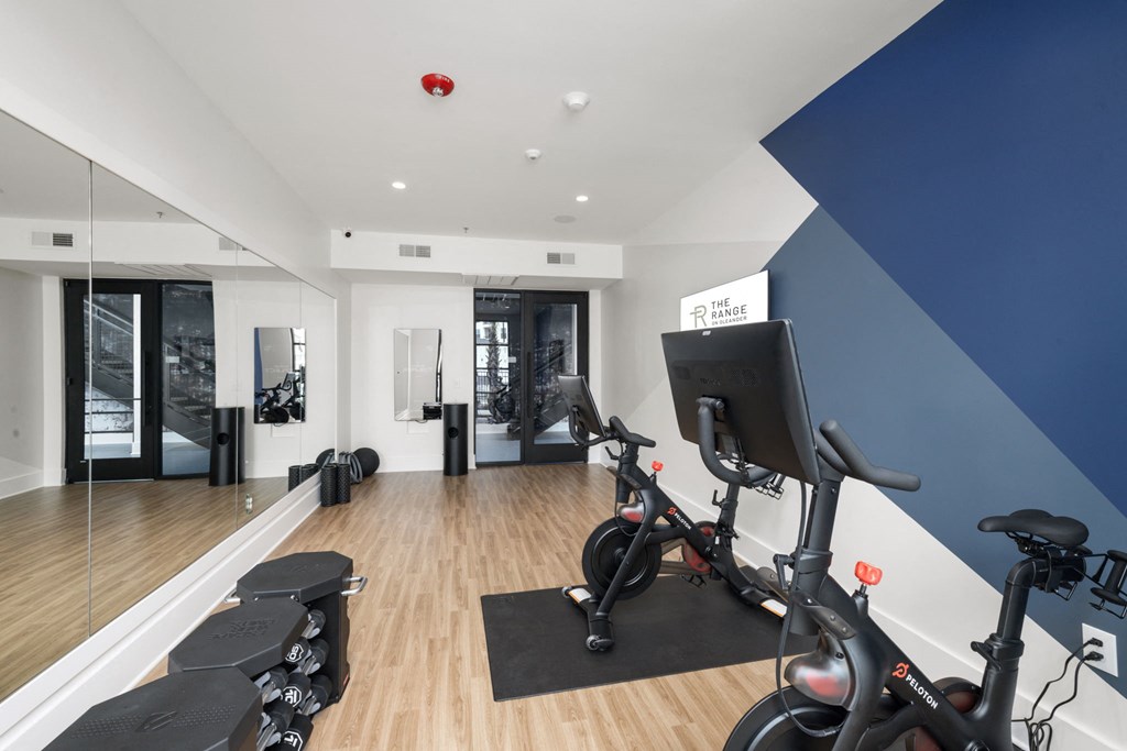 A gym with exercise bikes and weights.