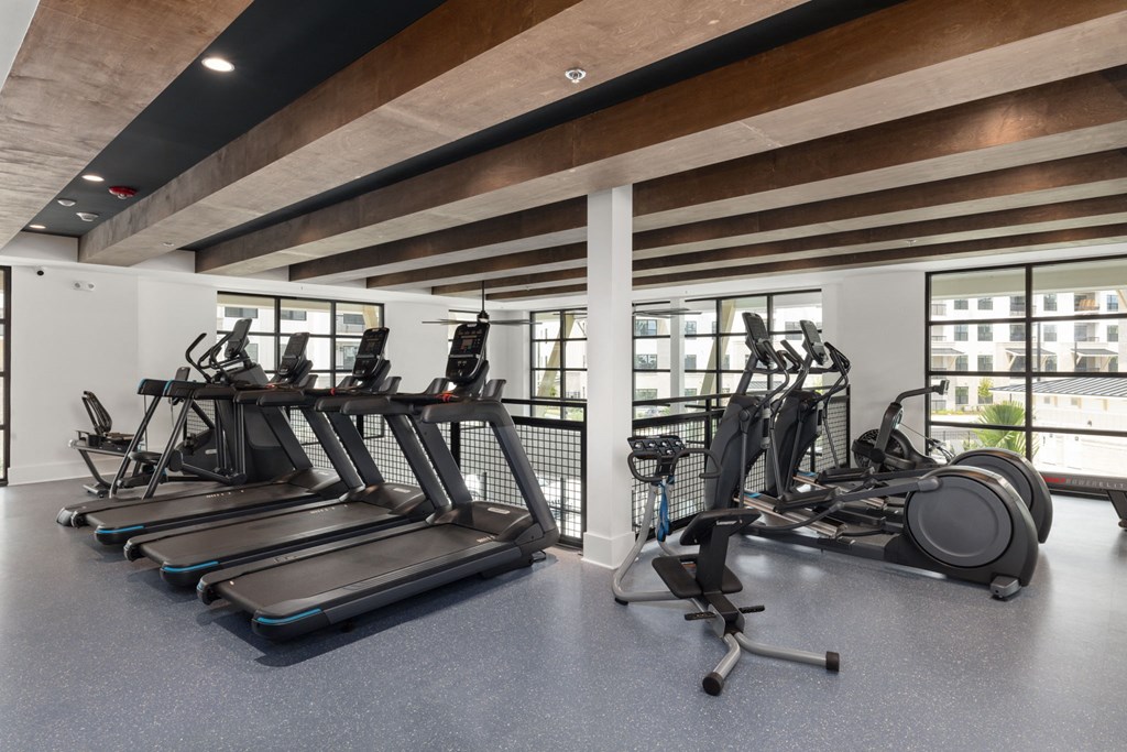A gym with treadmills and exercise bikes.