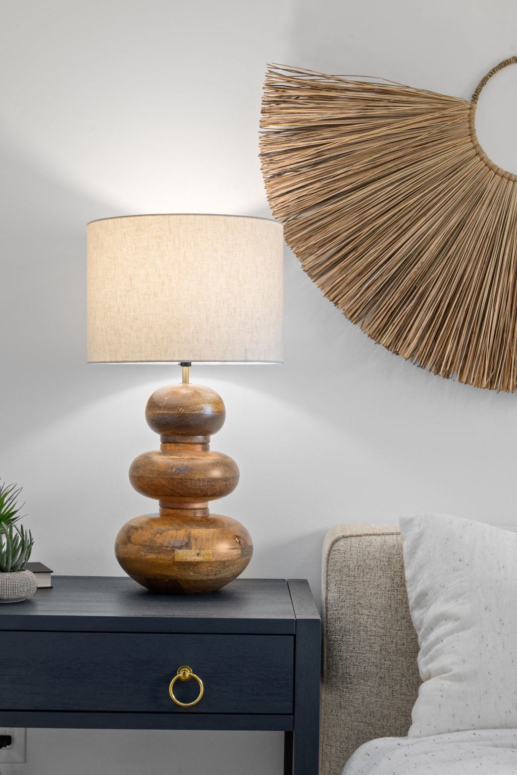 a table with a lamp and a mirror on the wall