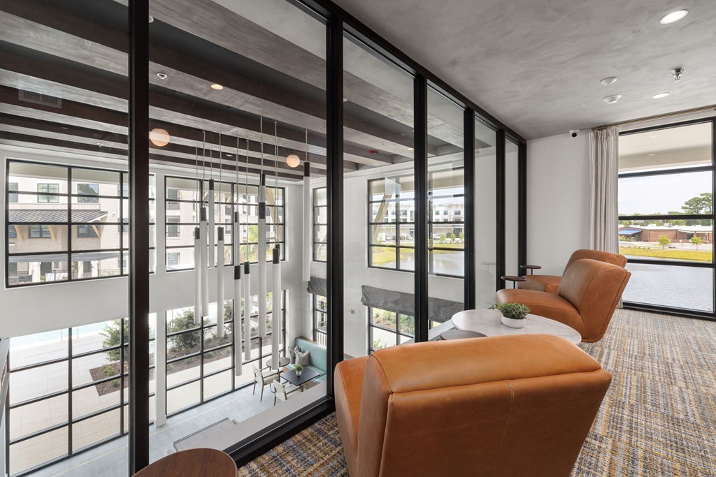 a living room with leather chairs and a table