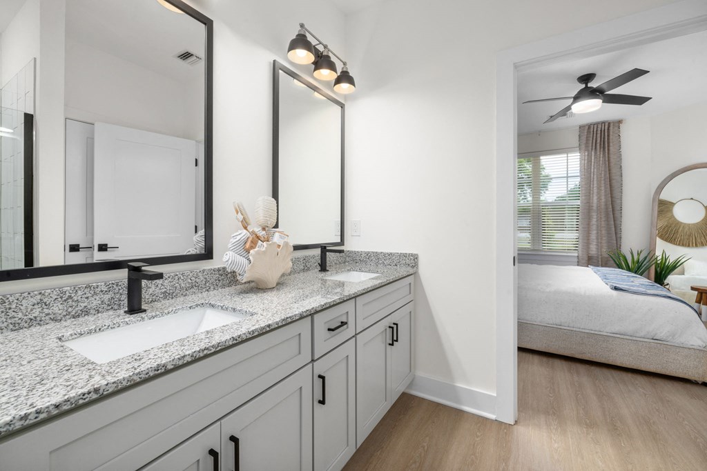 a view of a bathroom with a mirror and a sink