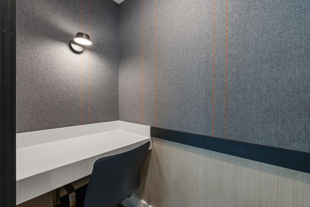 a small office with a desk and a chair