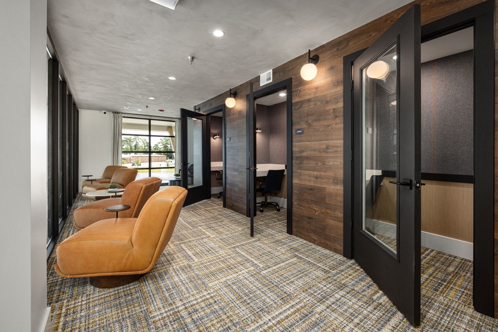 a conference room with chairs and desks and a glass door