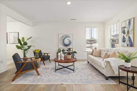 A living room with a white couch, a coffee table, and a rug.