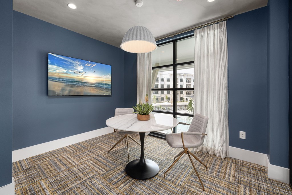 a dining room with a table and chairs and a large window