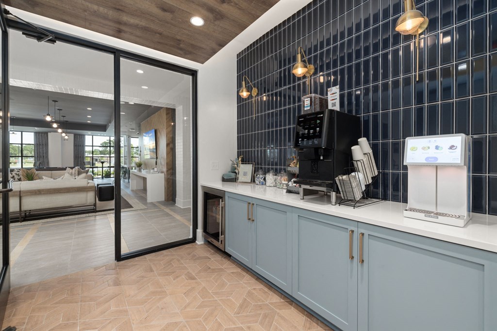 A modern kitchen with a black fridge and a black microwave.
