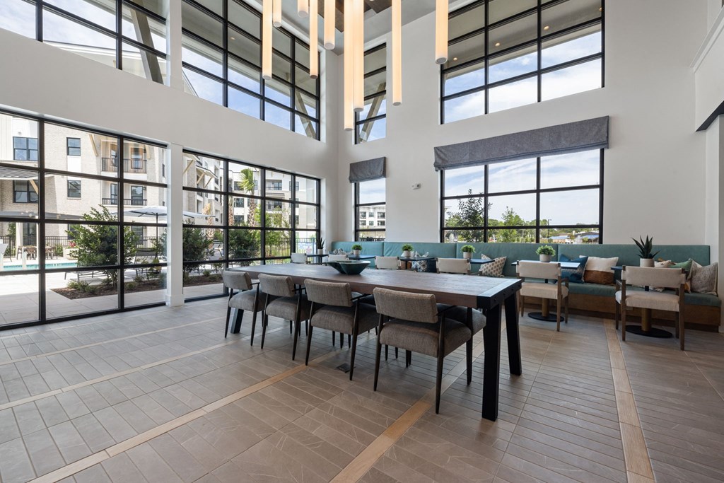 A large dining room with a long table and chairs.