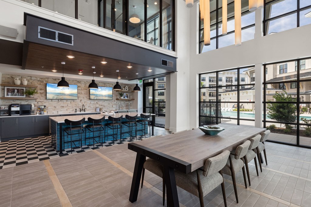 A modern kitchen with a dining table and chairs.