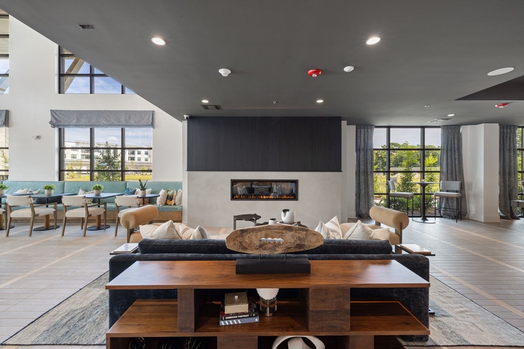 a large living room with a couch and a table