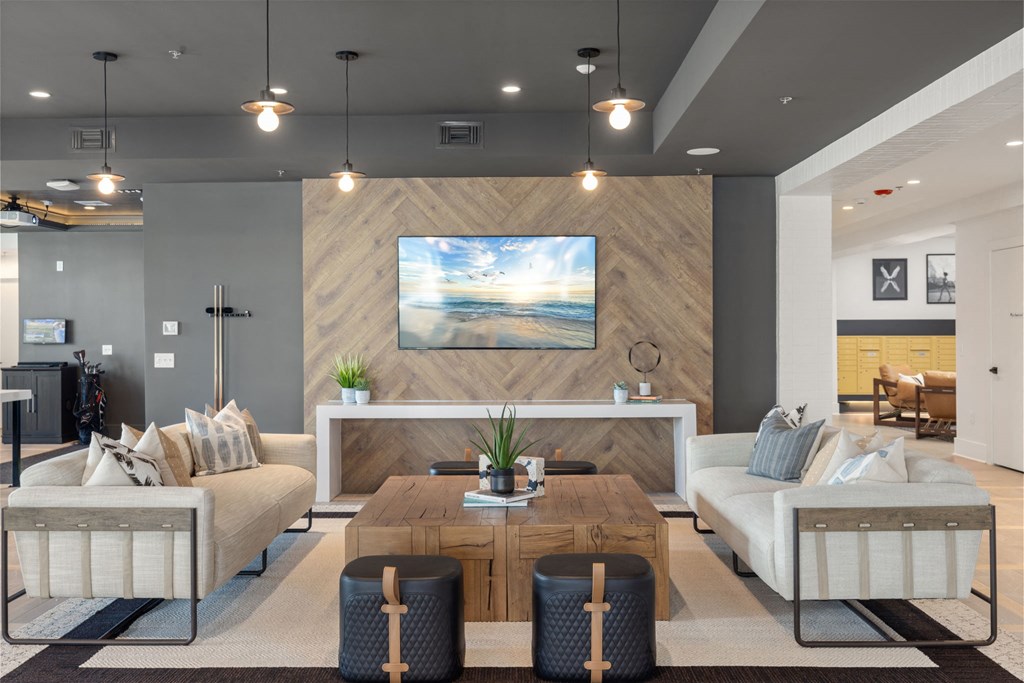 A modern living room with a large painting on the wall and a white sofa.