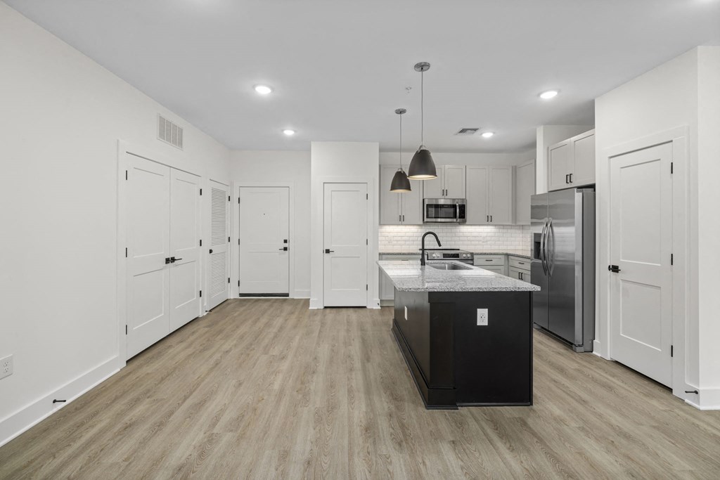 an open kitchen with white cabinets and a counter top in a house