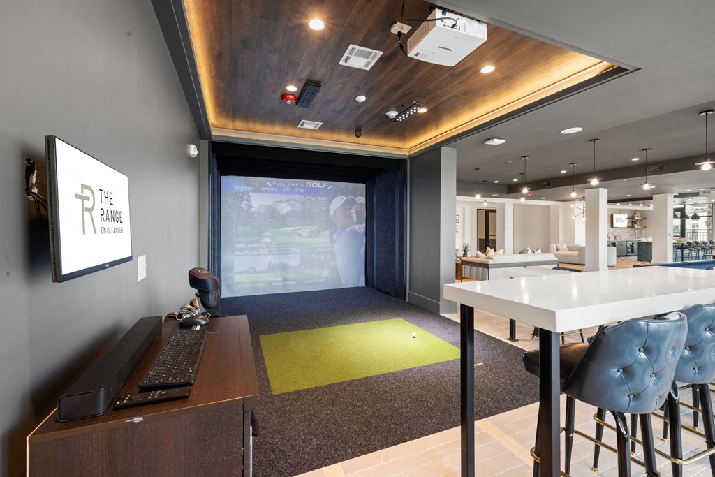 a conference room with a projector screen and a table with chairs